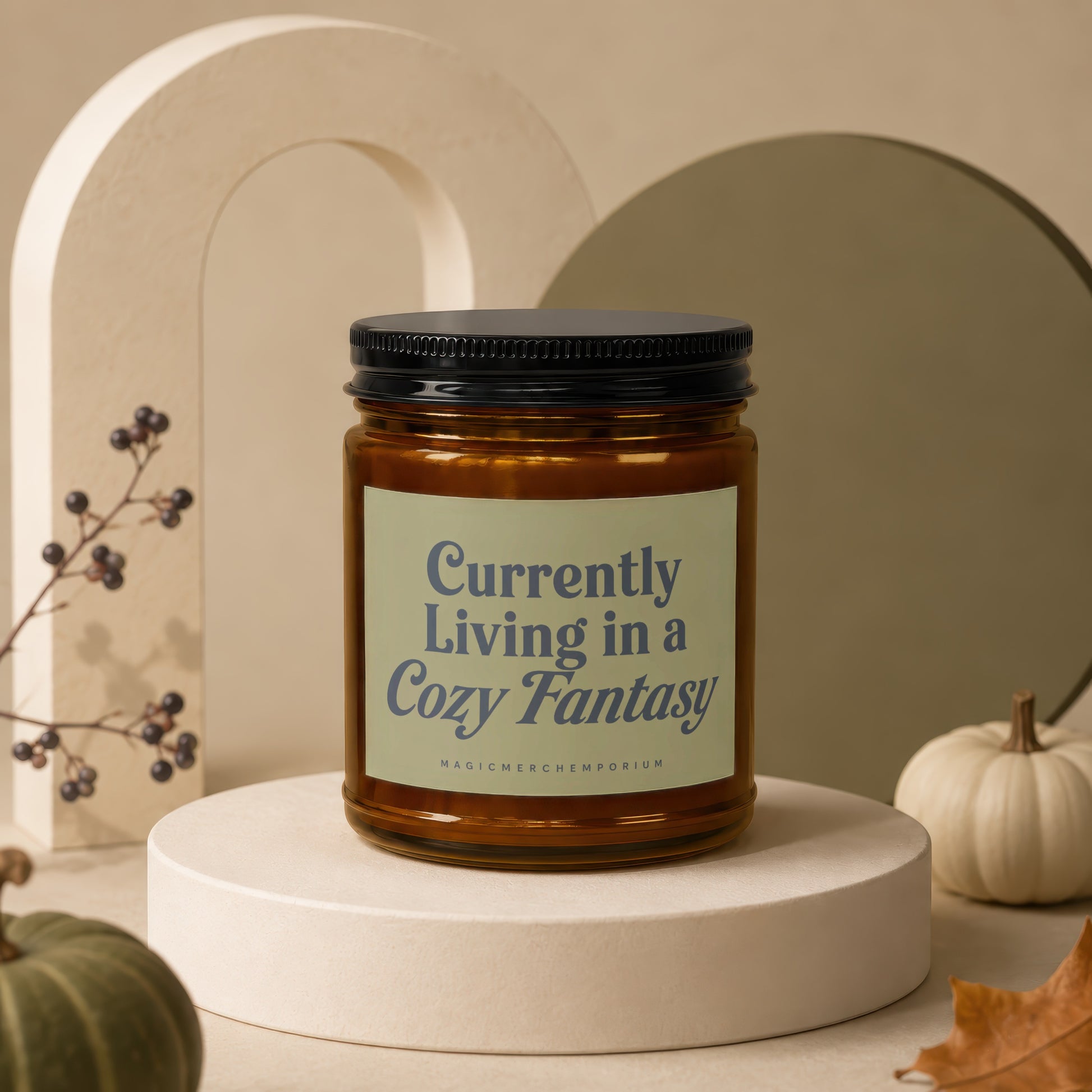 Amber glass candle with black lid and "Currently Living in a Cozy Fantasy" label.