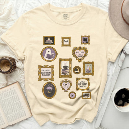 T-shirt with framed illustrations: ghost reading, books, bat, cat, potion, spider, with text.