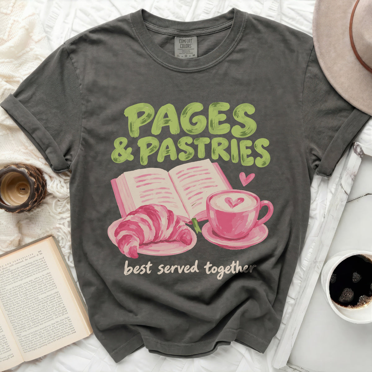 Dark gray t-shirt with "PAGES & PASTRIES best served together" text and illustrations.