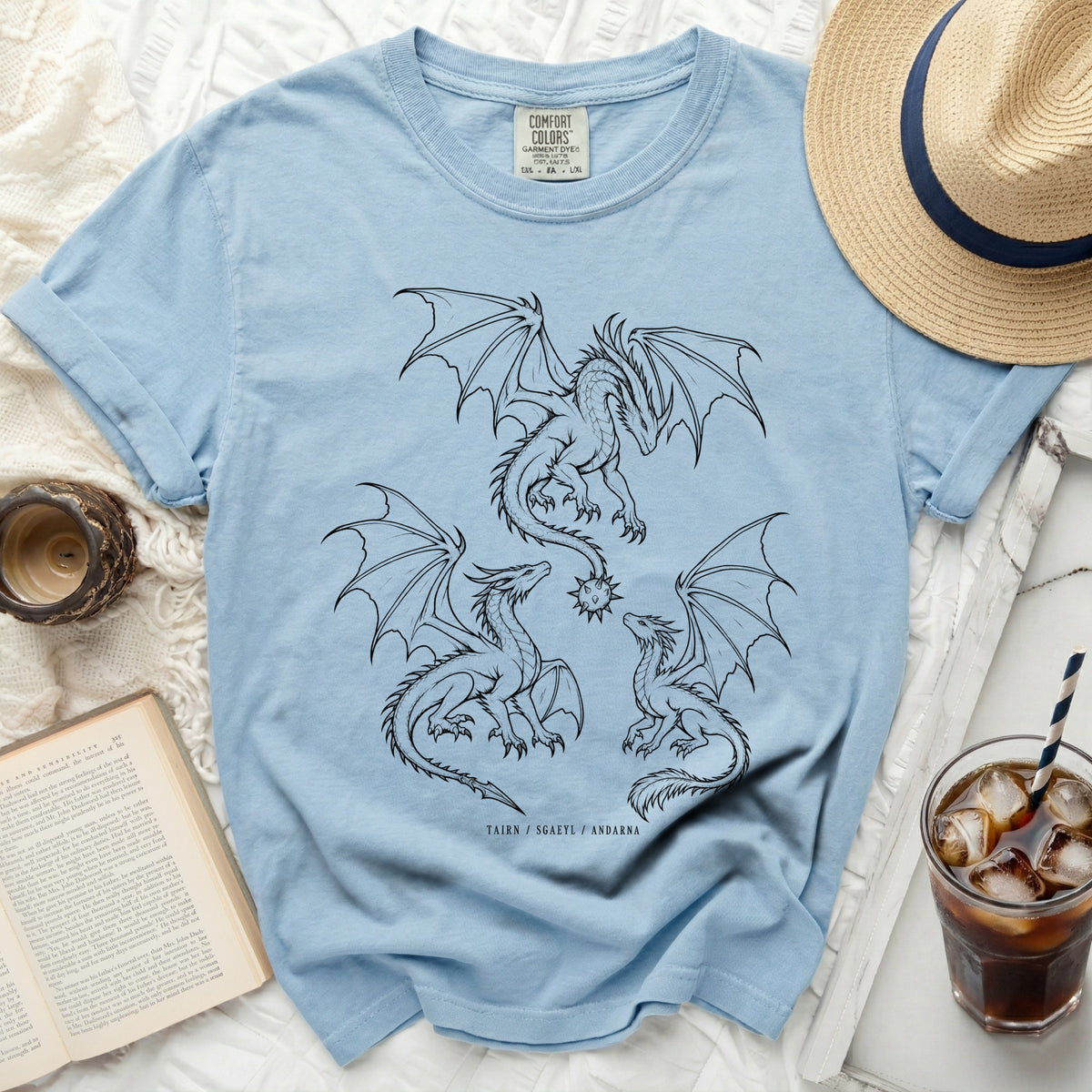 Light blue t-shirt with three black dragon graphic and text TAIRN / SGAEYL / ANDARNA.