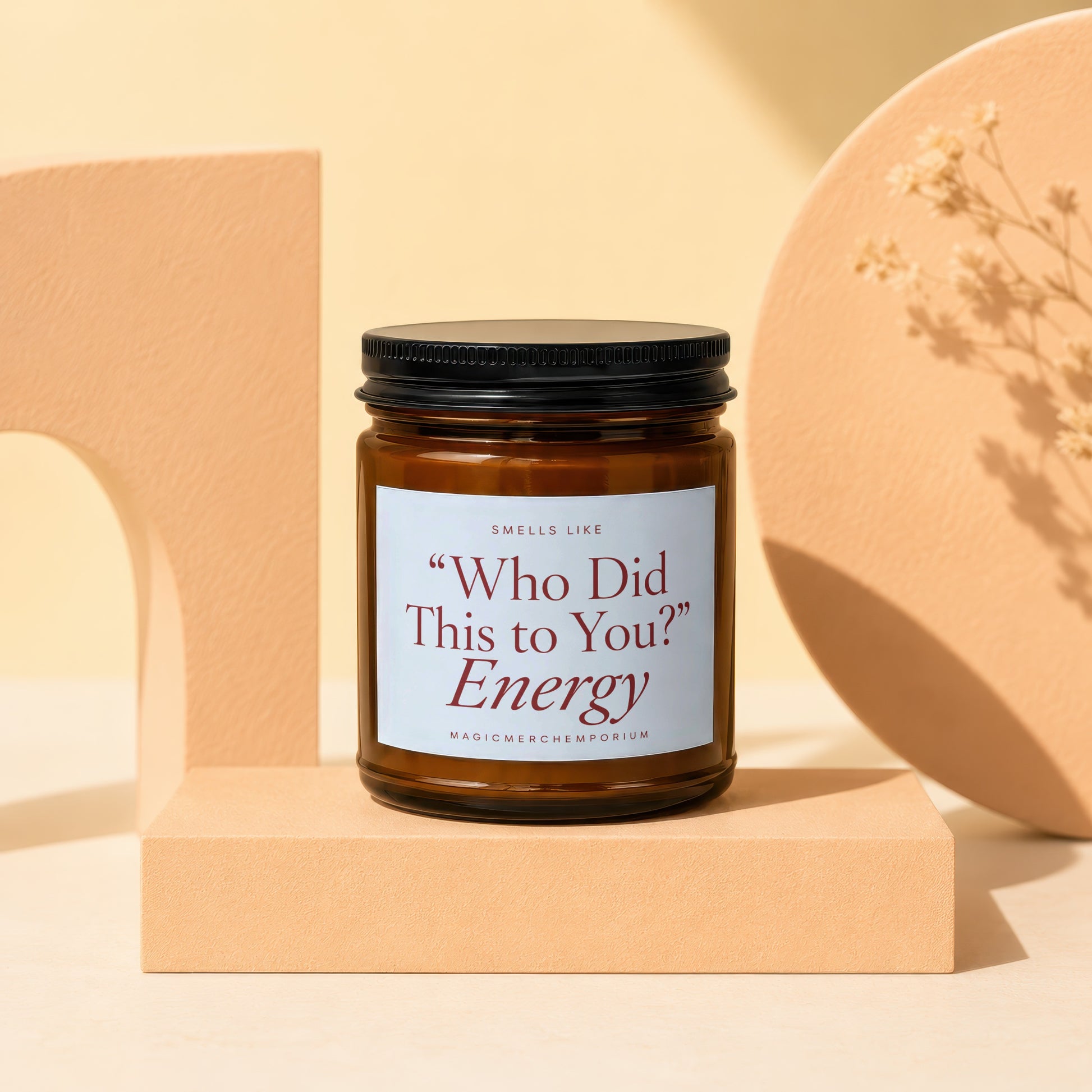 Amber candle with black lid labeled "Who Did This to You?" Energy.