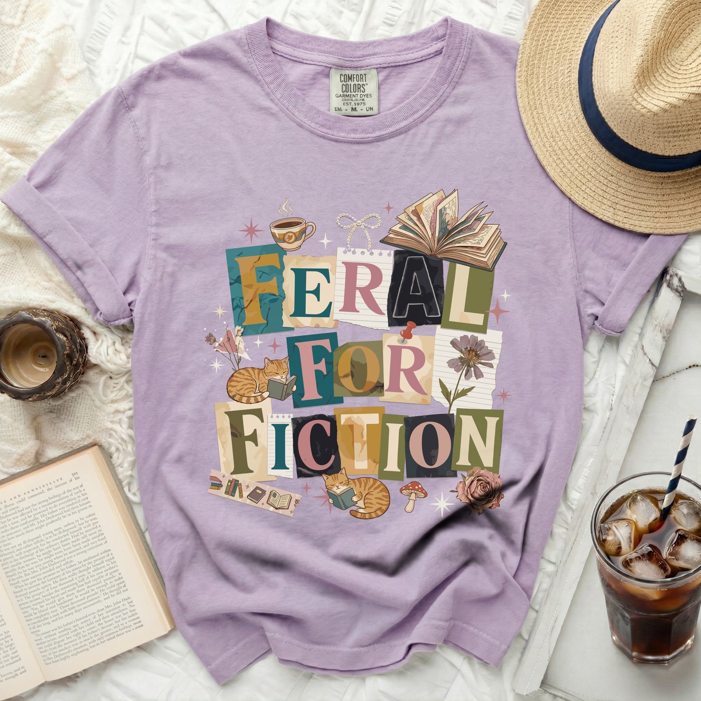 Lavender t-shirt with "Feral for Fiction" text, books, coffee, and cats graphic.