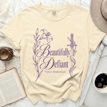 Cream t-shirt with purple "Beautifully Defiant Violet Sorrengail" text and floral design.