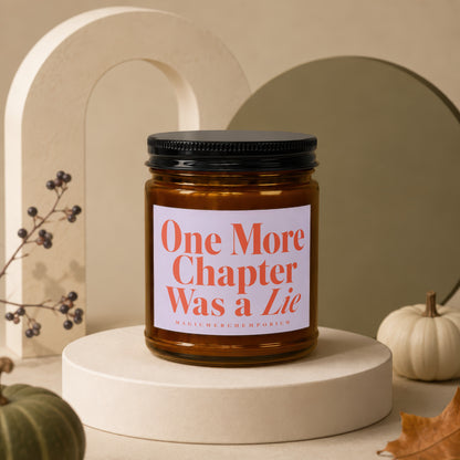 Amber candle with black lid reads "One More Chapter Was a Lie".
