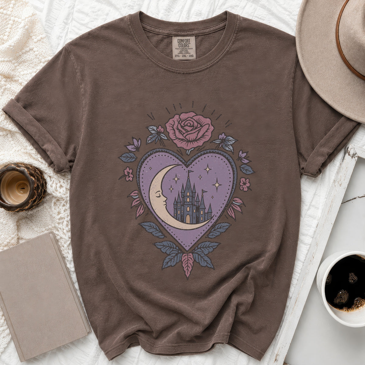 Brown t-shirt with crescent moon, castle, rose, and starry heart graphic.