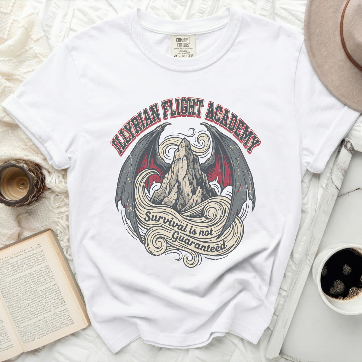 White t-shirt with "Illyrian Flight Academy" and "Survival is not Guaranteed" graphic.