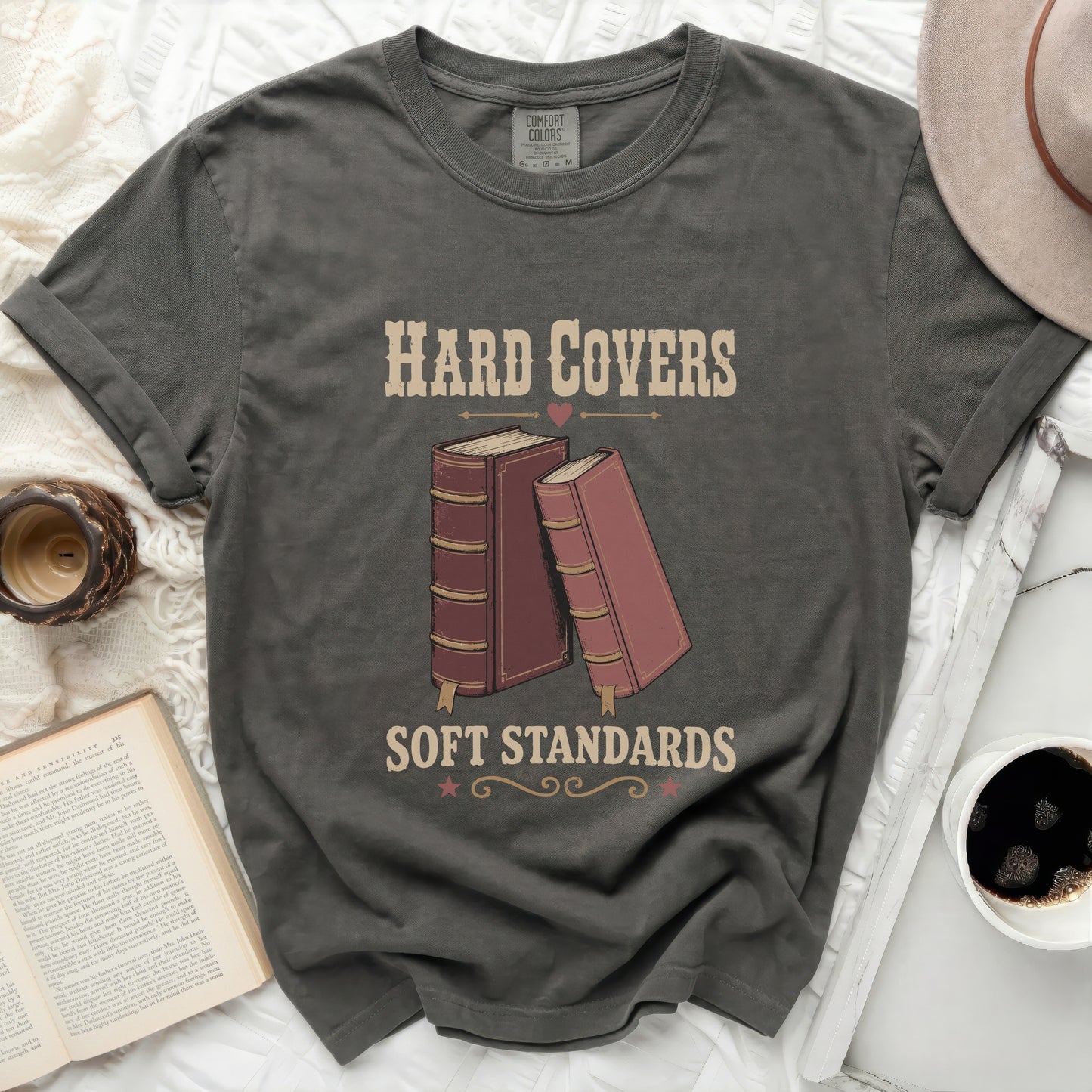 Graphic tee with "Hard Covers Soft Standards" text and two books.