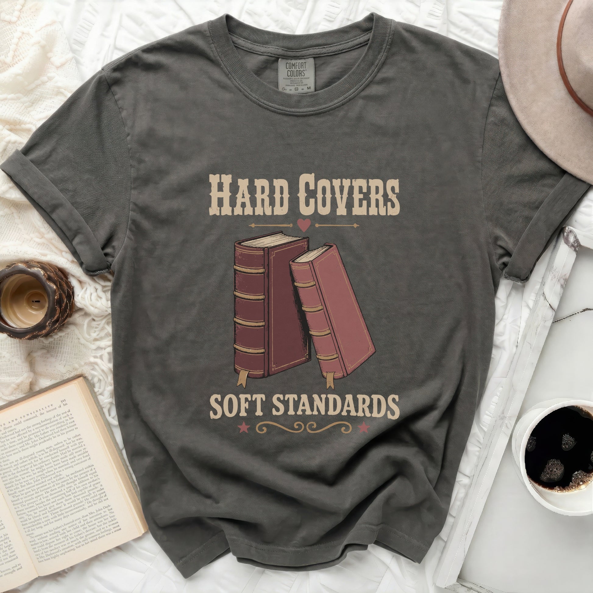 Graphic tee with "Hard Covers Soft Standards" text and two books.