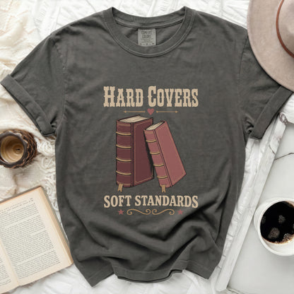 Graphic tee with "Hard Covers Soft Standards" text and two books.