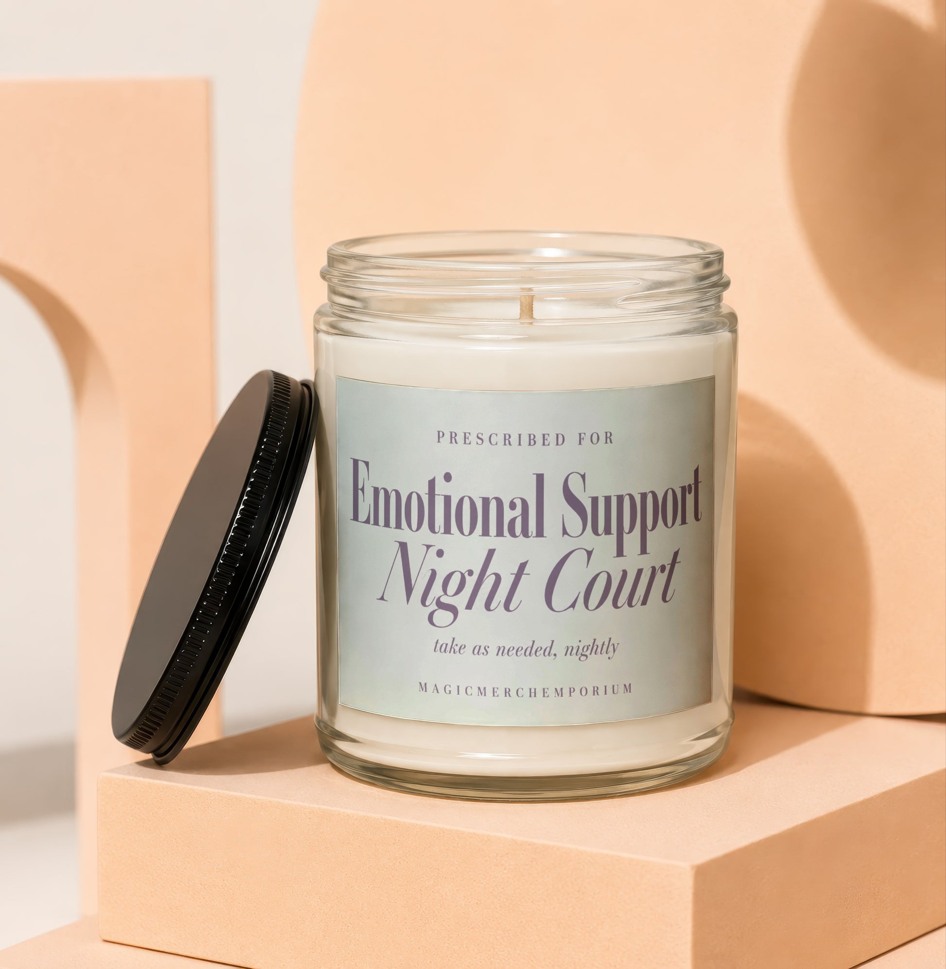 Glass jar candle labeled "Emotional Support Night Court" with "take as needed, nightly" text.