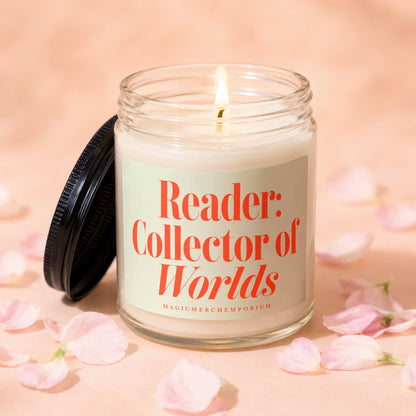 Lit glass candle with black lid, reading "Reader: Collector of Worlds"