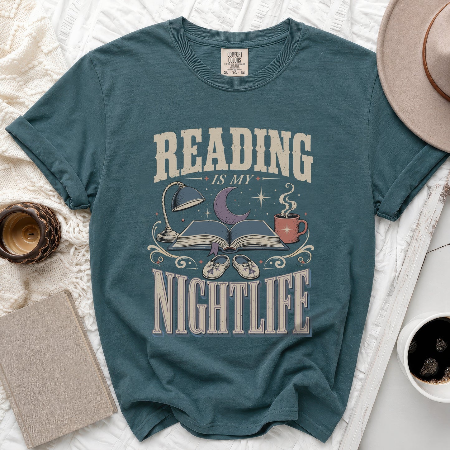 Teal t-shirt with "READING IS MY NIGHTLIFE" graphic featuring books, moon, and coffee cup.