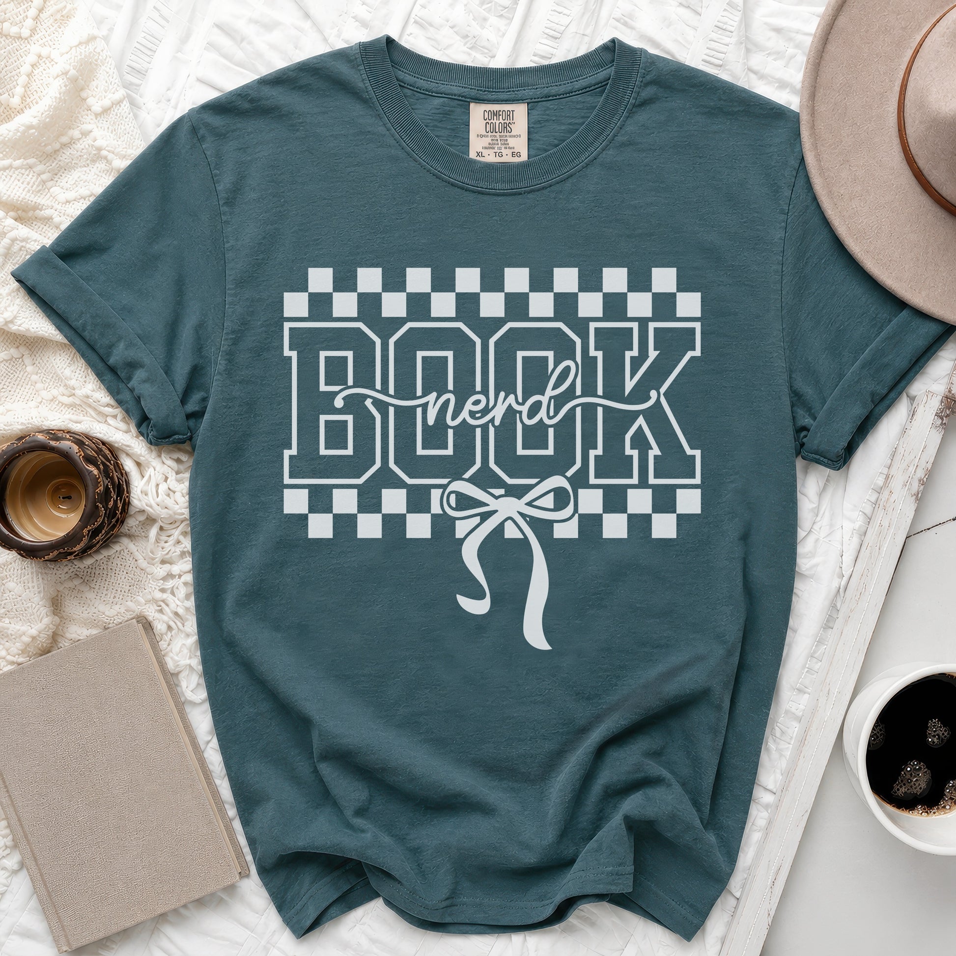 Teal t-shirt with "BOOK nerd" graphic and checkered border.