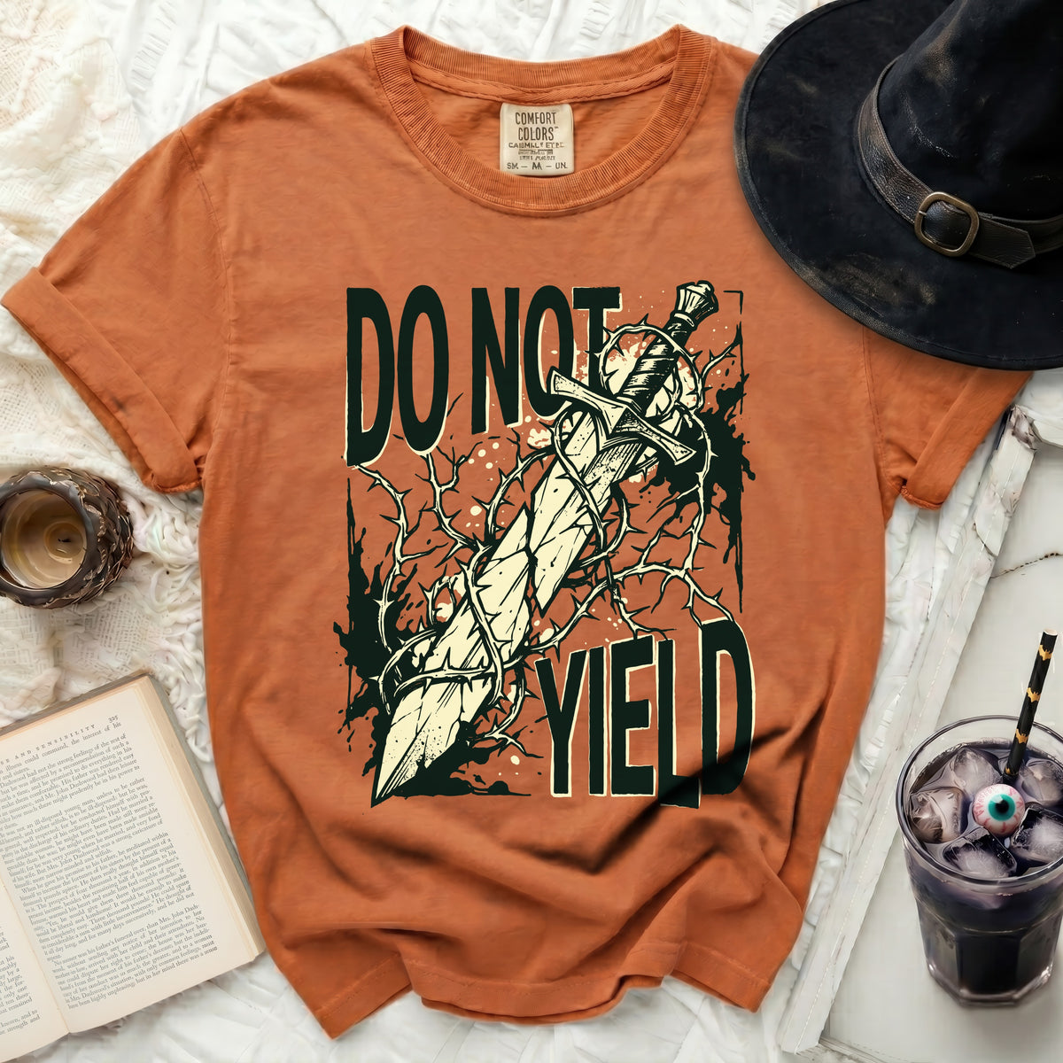Orange t-shirt with "DO NOT YIELD" and a sword graphic.