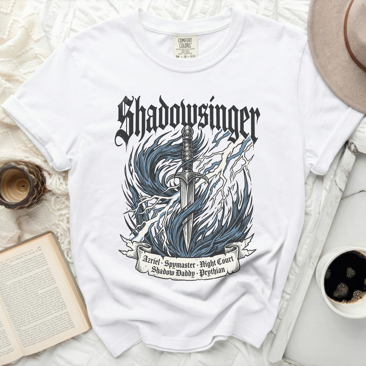 White t-shirt with "Shadowsinger" graphic, sword, flames, lightning, and text.