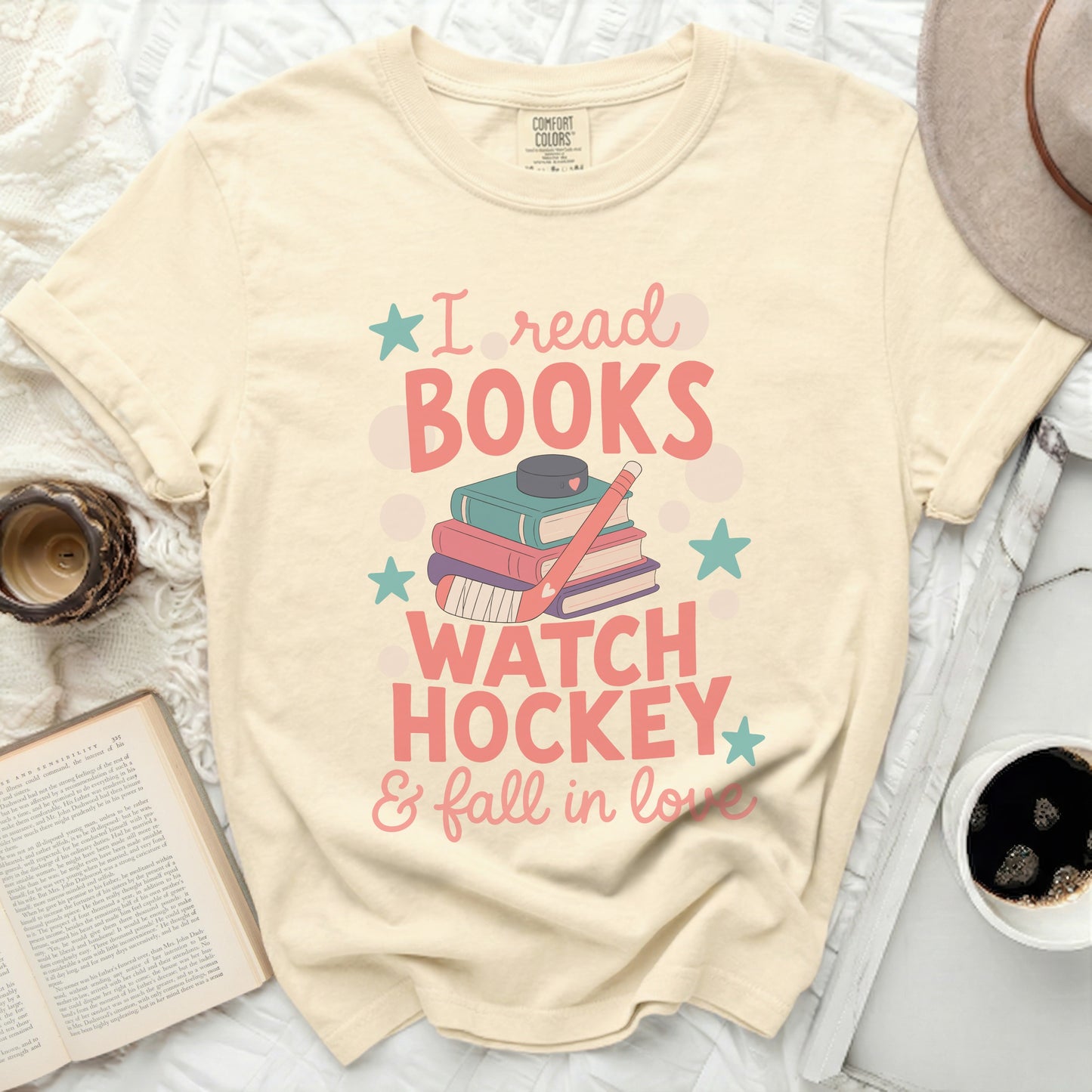 Cream t-shirt with "I read books watch hockey & fall in love" graphic.