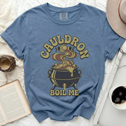 Blue t-shirt with a cauldron graphic and text that reads "CAULDRON BOIL ME".