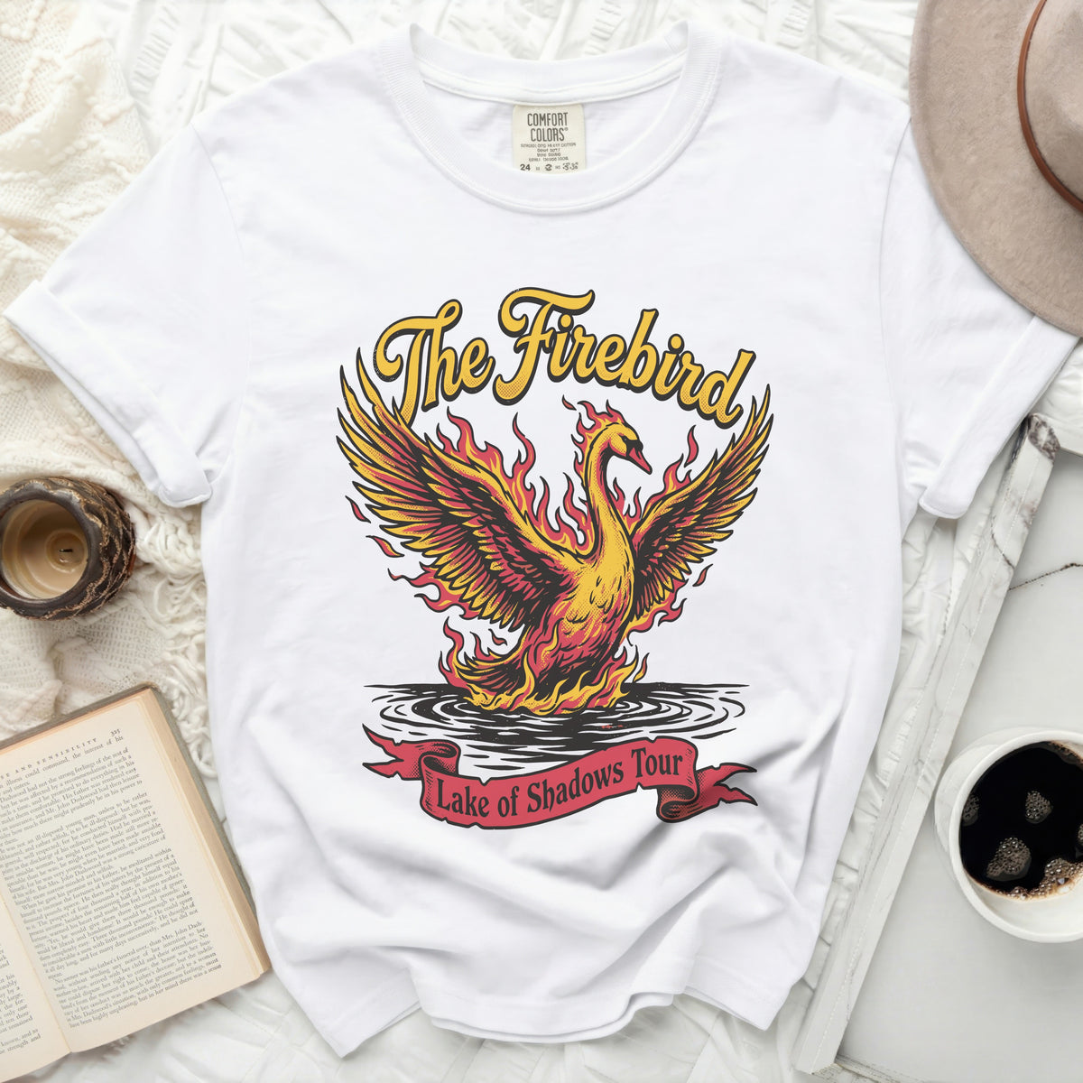 White t-shirt with a fiery phoenix and "The Firebird Lake of Shadows Tour" text.