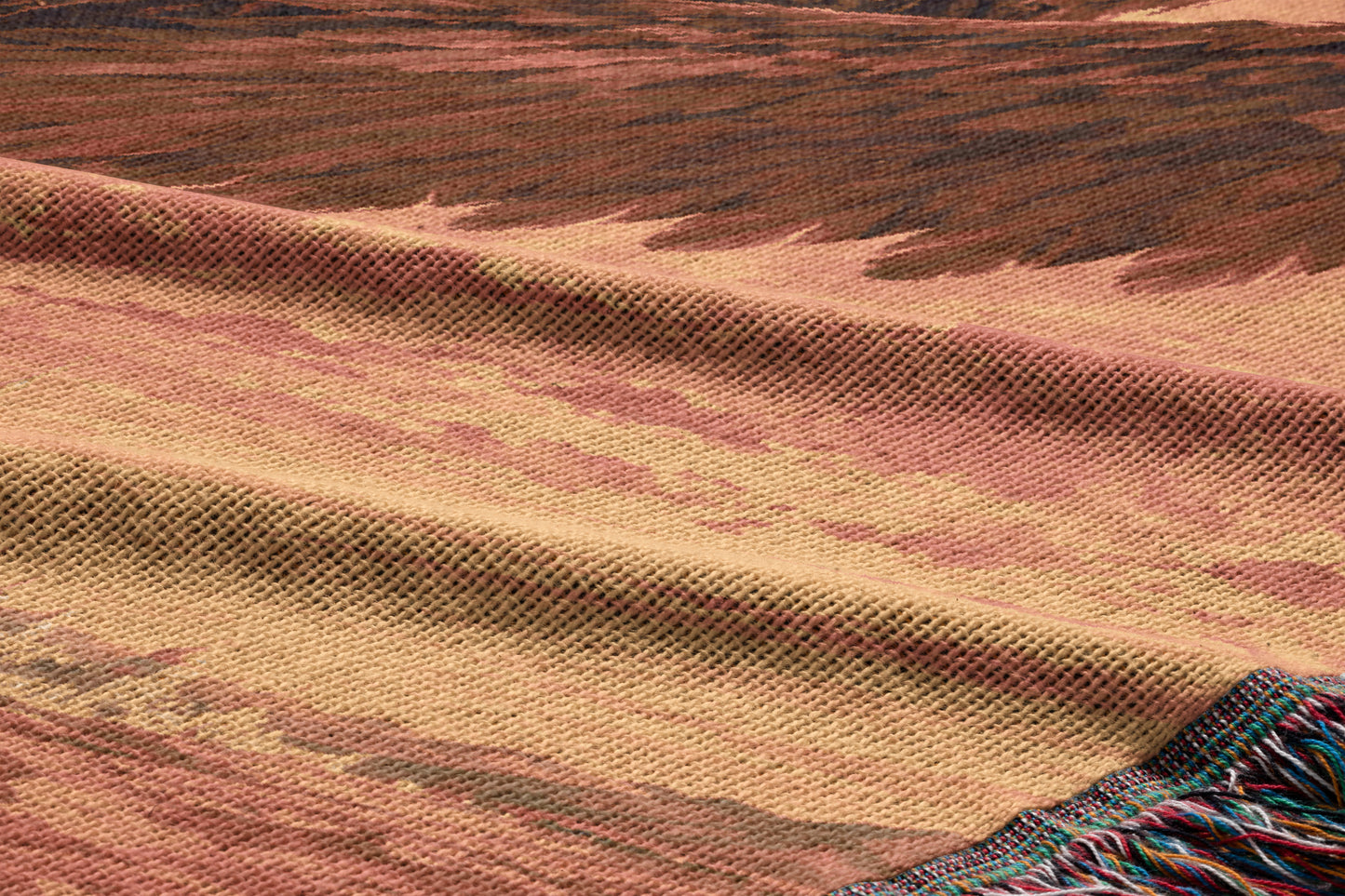 a close-up view of a woven fabric with a textured pattern, featuring a mix of warm colors such as brown, orange, and beige.