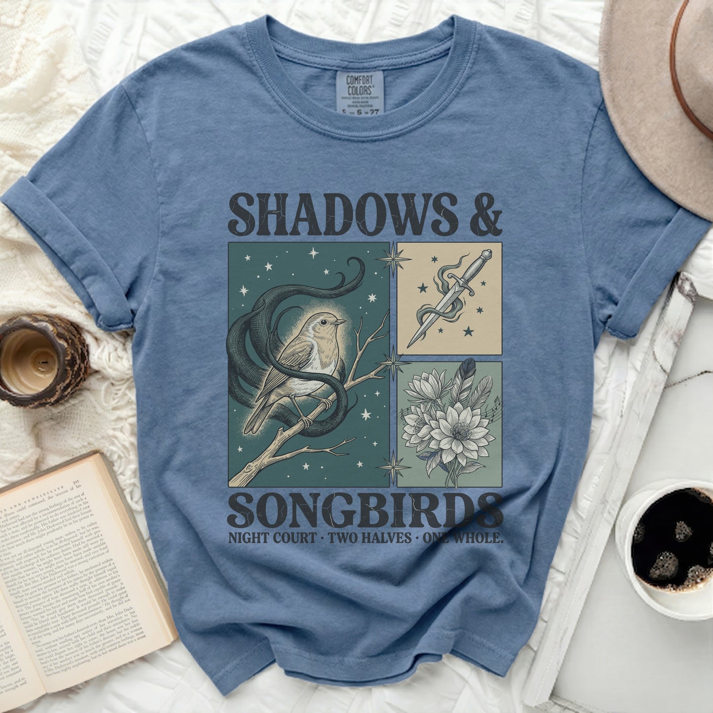T-shirt with "Shadows & Songbirds" text and illustrative panels.