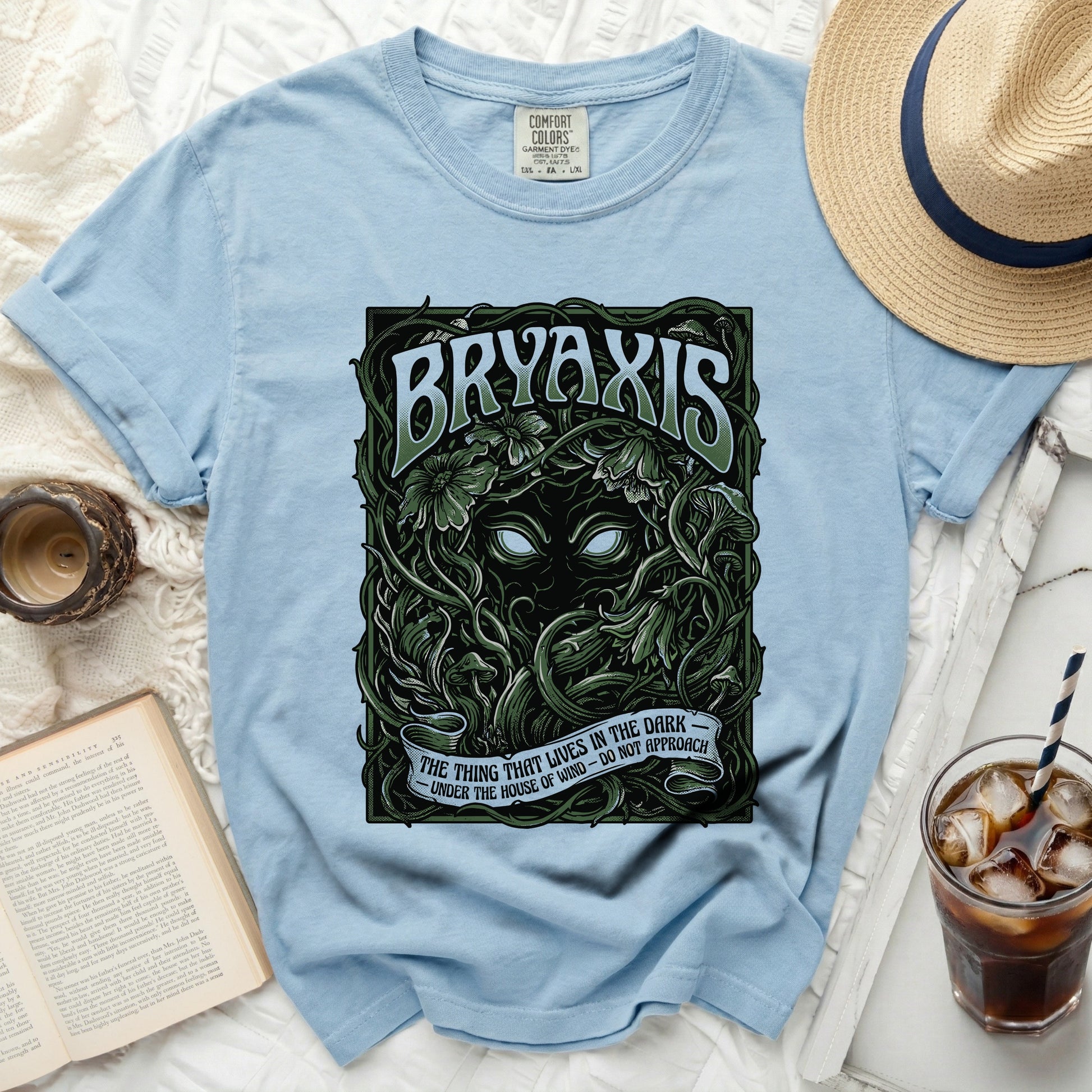Light blue t-shirt with green "BRYAXIS" text and gothic forest illustration.