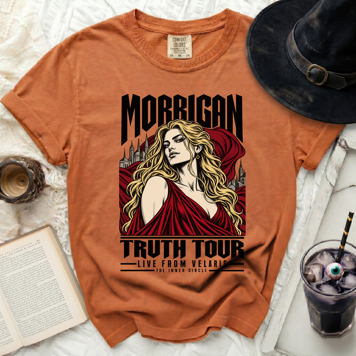 Orange t-shirt with "Morrigan Truth Tour Live From Velaris The Inner Circle" graphic.