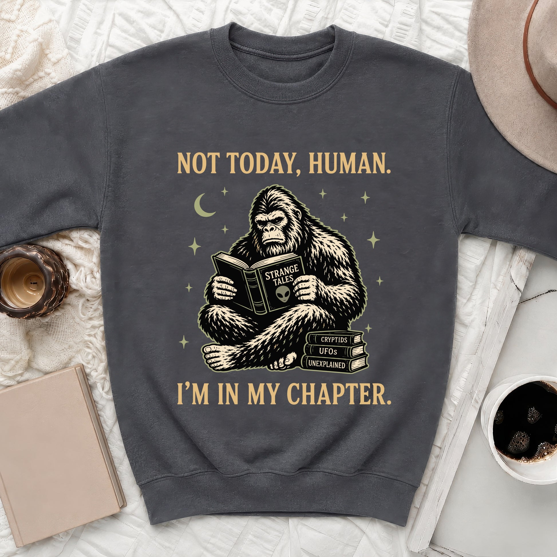 Bigfoot reads a book titled "Strange Tales" with text "I'm in my chapter."