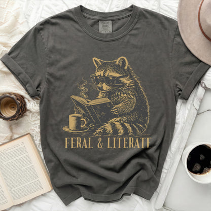 Dark gray t-shirt with a graphic of a raccoon wearing glasses reading a book.