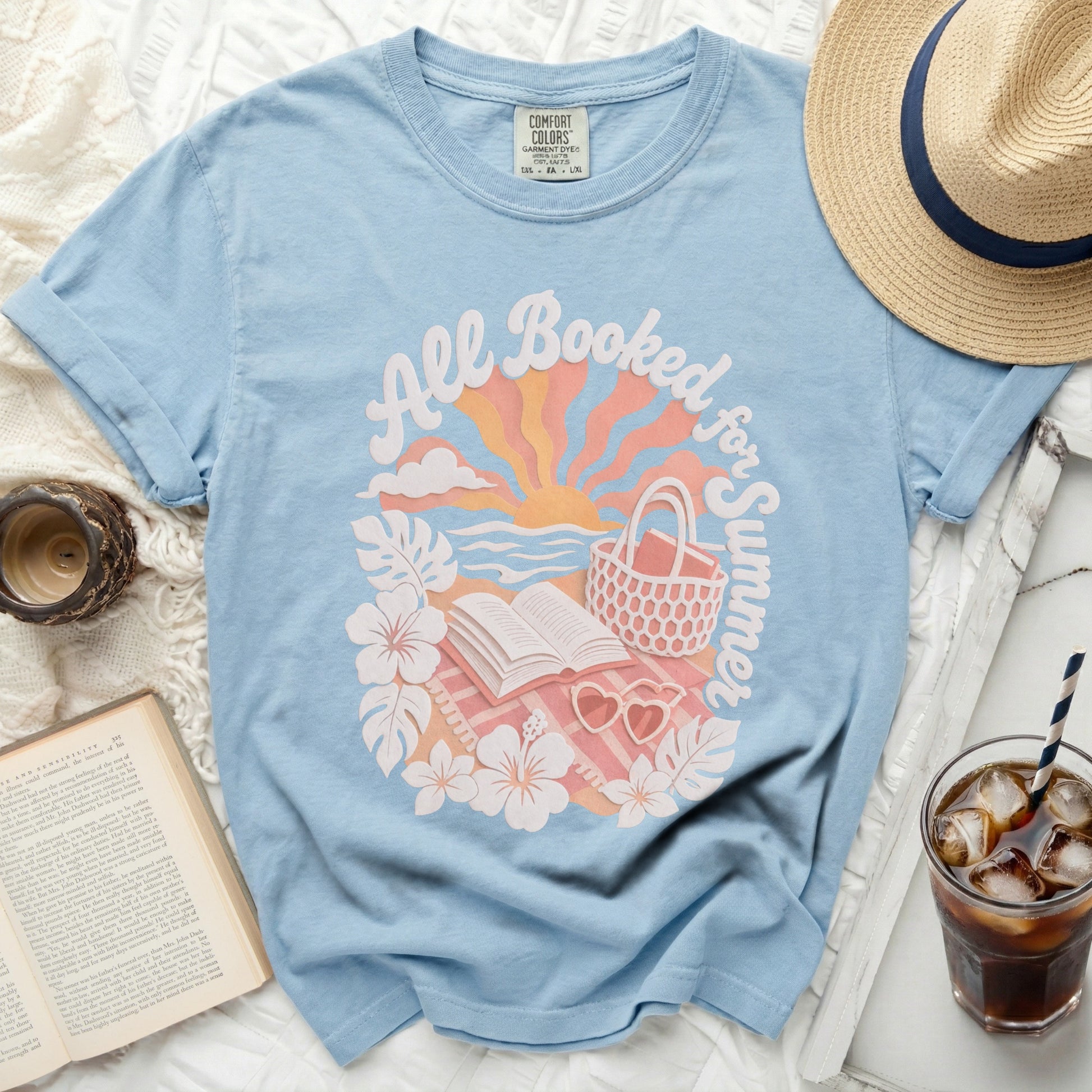 Blue t-shirt with "All Booked for Summer" graphic and open book.