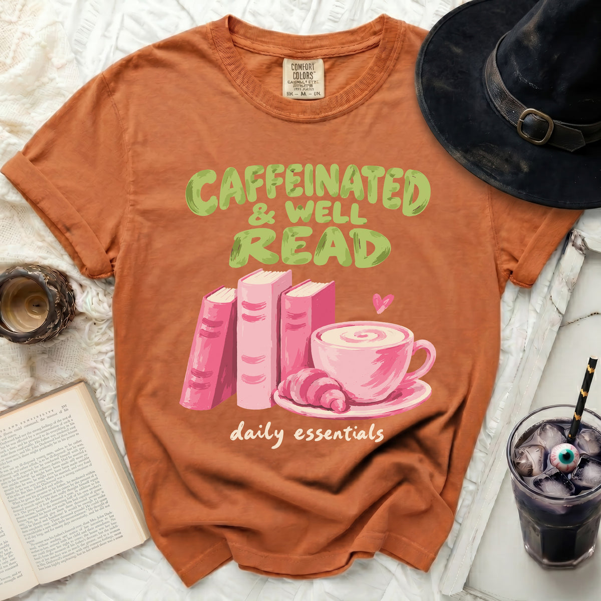 T-shirt with "Caffeinated & Well Read" graphic, books, and coffee cup.