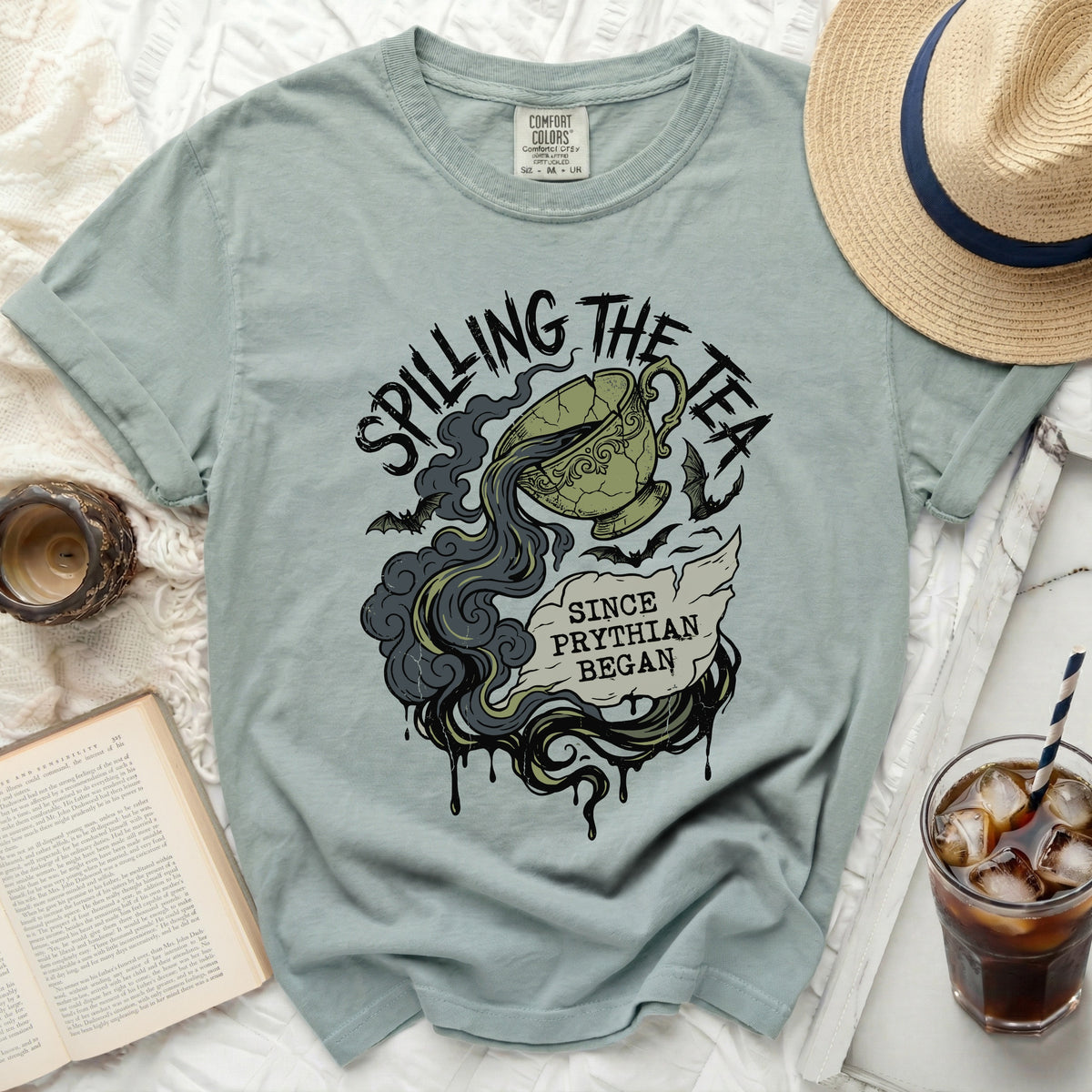 T-shirt with "Spilling the Tea Since Phythian Began" text and a cracked teacup.