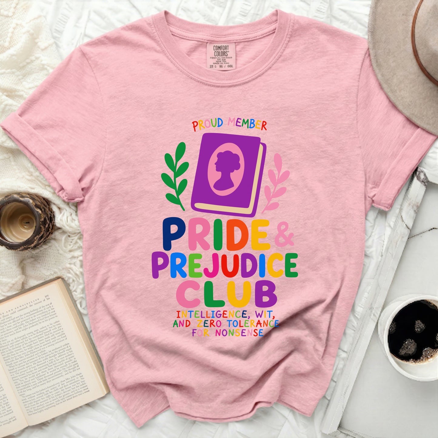 Pink t-shirt with "Proud Member | Pride & Prejudice Club" text and graphics.