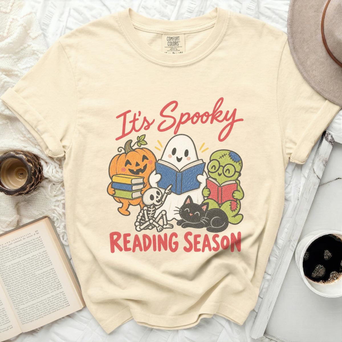 It's Spooky Reading Season graphic with cartoon Halloween characters on a cream t-shirt.