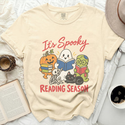 It's Spooky Reading Season graphic with cartoon Halloween characters on a cream t-shirt.