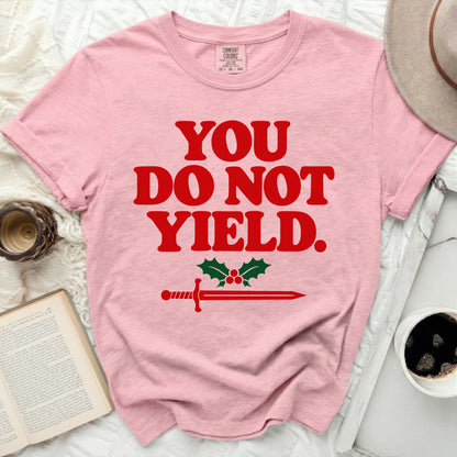 Pink t-shirt with red text "YOU DO NOT YIELD." and sword with holly.