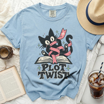 Light blue t-shirt with a black cat graphic and "PLOT TWIST" text.
