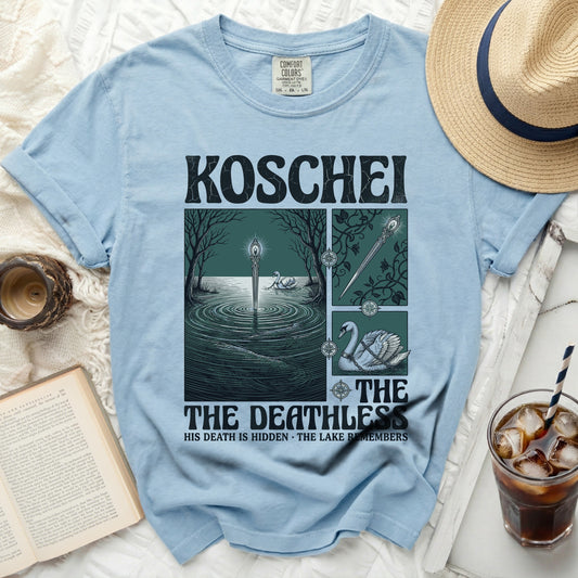 Light blue t-shirt with "KOSCHEI THE DEATHLESS" graphic of a lake and swan.