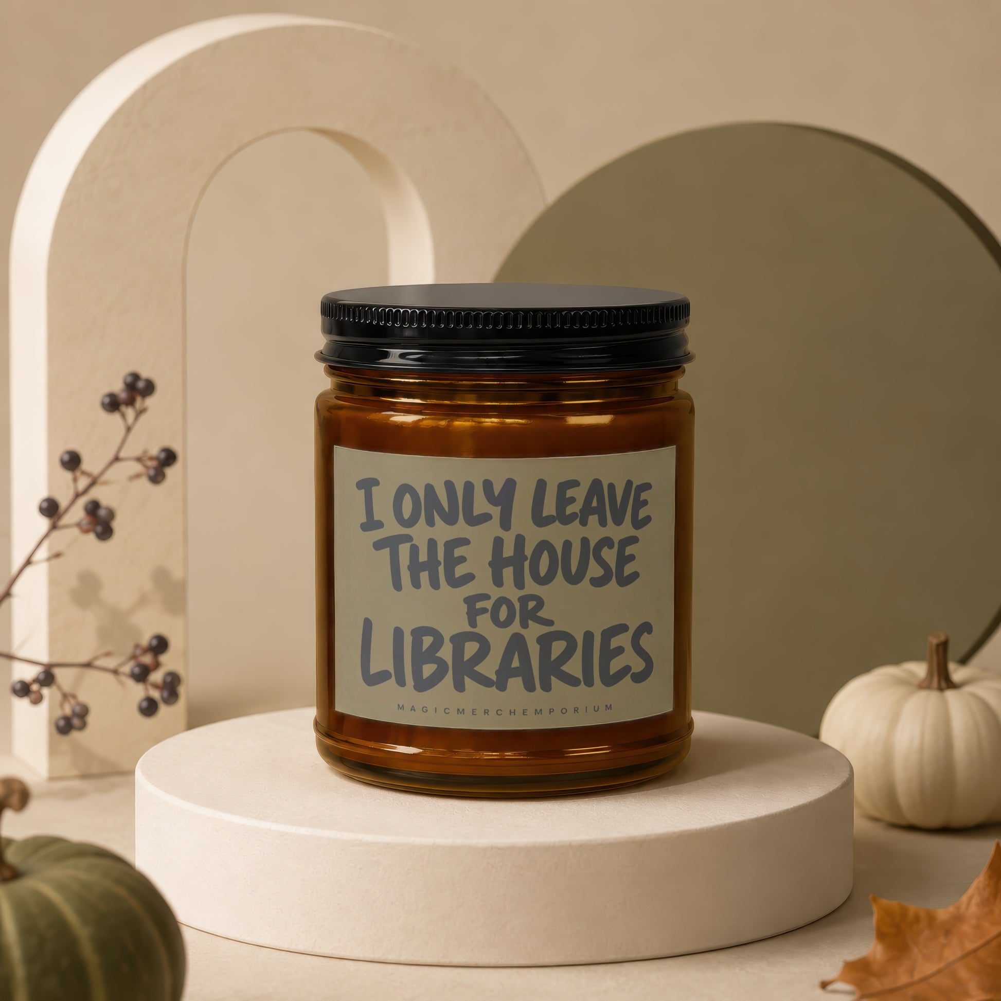 Amber candle with "I only leave the house for libraries" text on label.
