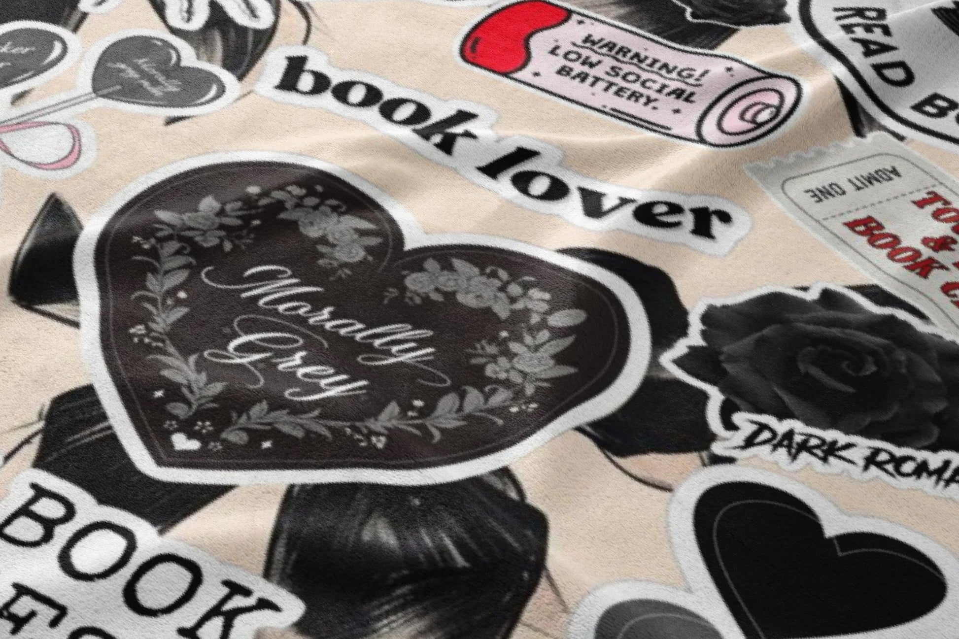 Stickers with "book lover" and "Morally Grey" text, dark roses, and a low battery warning.