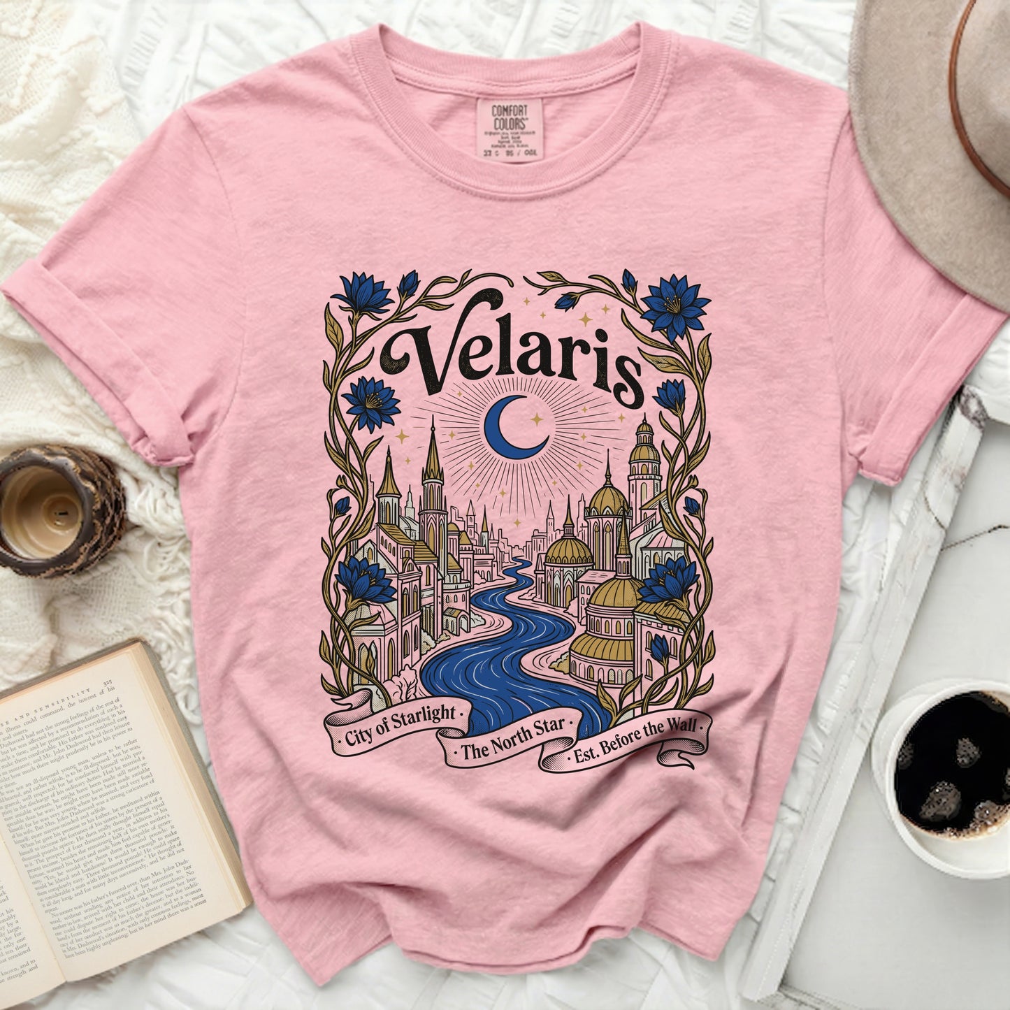 Pink Comfort Colors t-shirt with "Velaris City of Starlight" celestial landscape graphic.