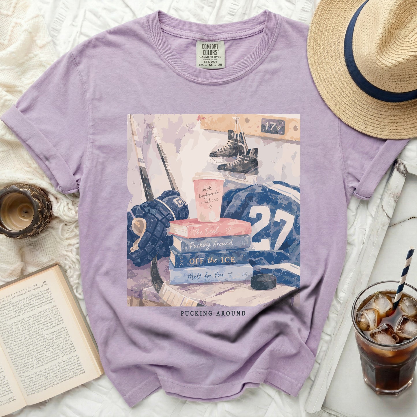 Purple t-shirt with hockey theme graphic and book.