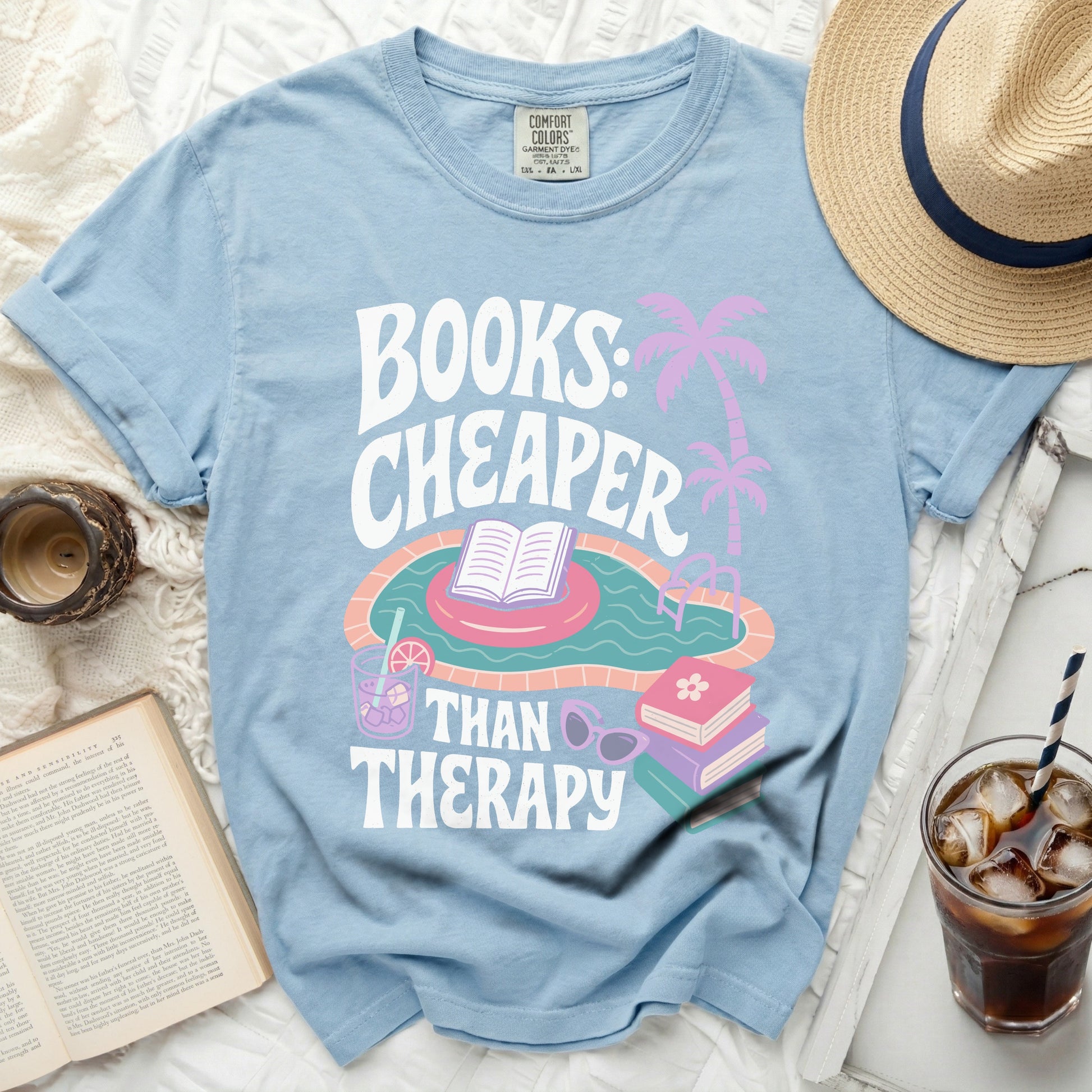 Blue t-shirt with "Books: Cheaper Than Therapy" text and pool graphics.