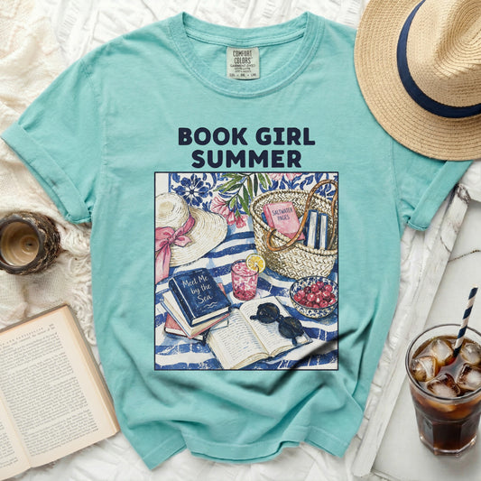 Blue t-shirt with "Book Girl Summer" design and beach reading accessories.