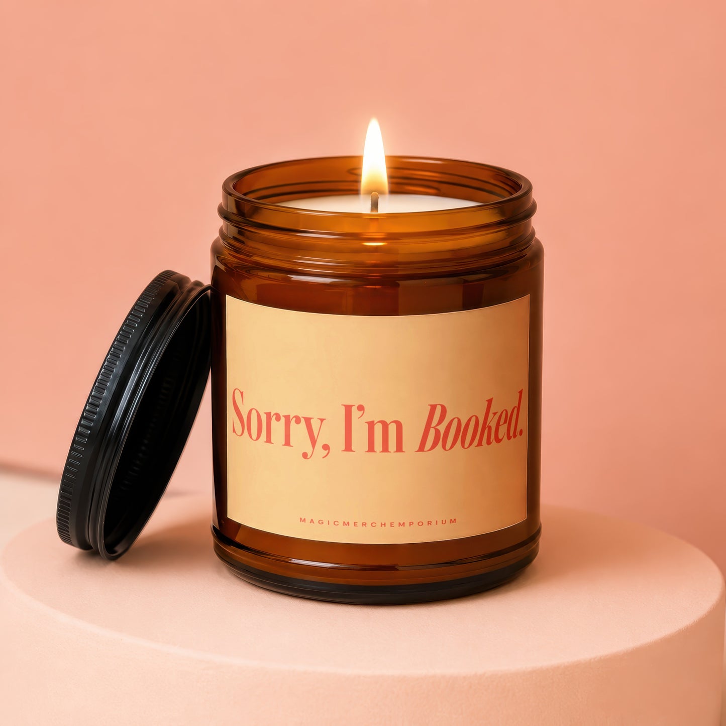 Amber jar candle with lit wick and text "Sorry, I'm Booked."