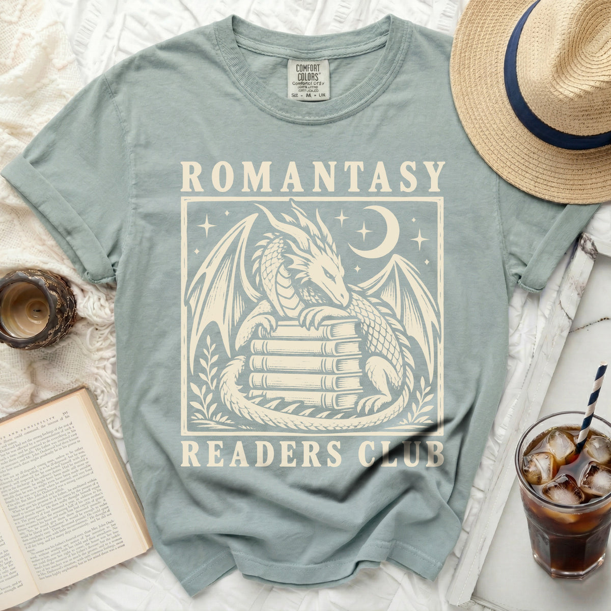 Green t-shirt with dragon on books graphic and text "ROMANTASY READERS CLUB".