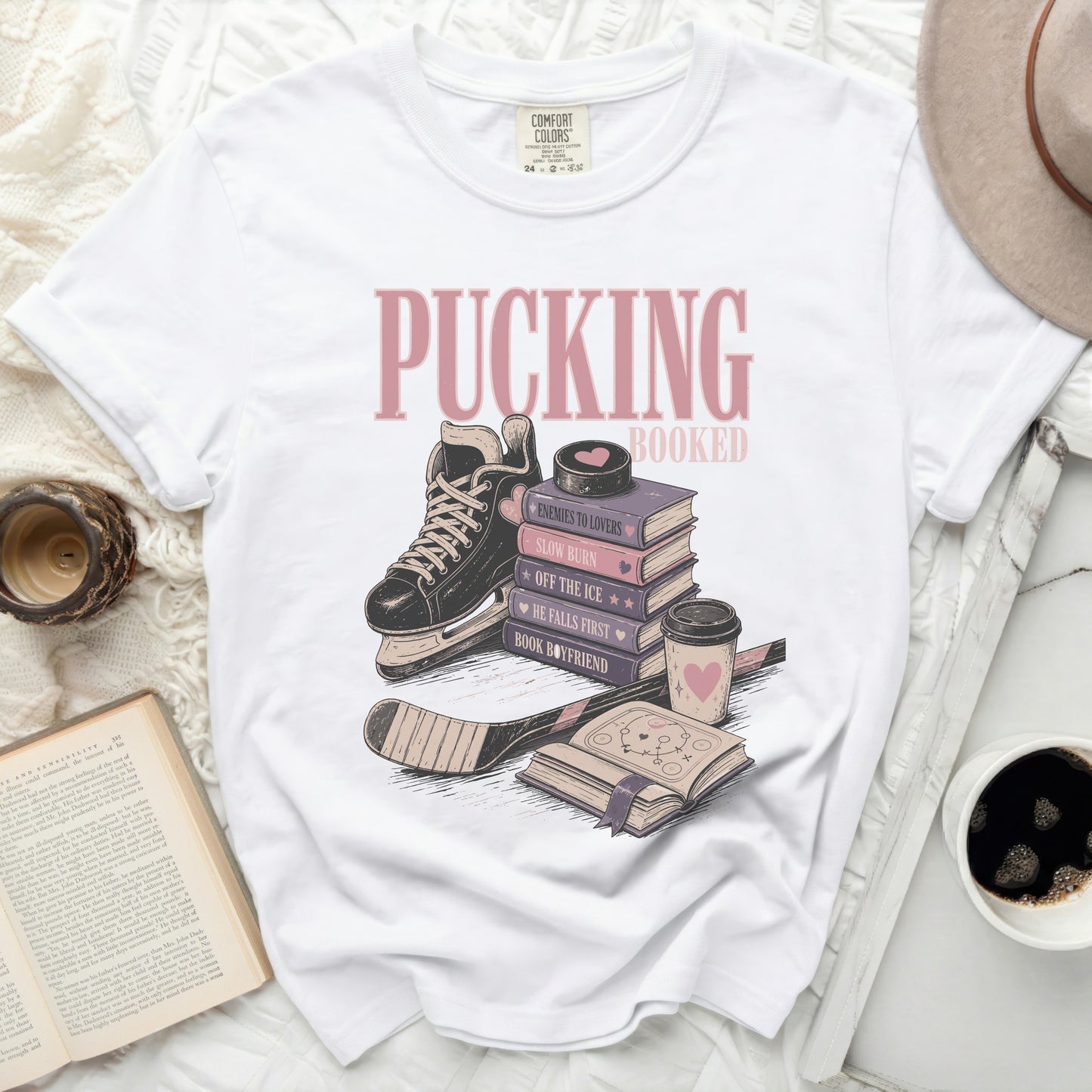White t-shirt with "Pucking Booked" and book-themed phrases.