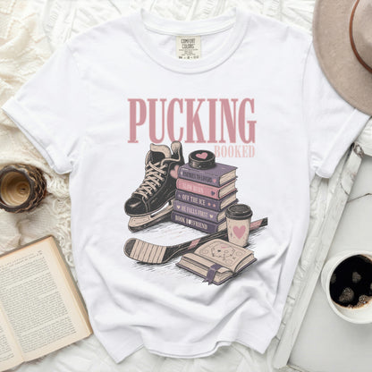 White t-shirt with "Pucking Booked" and book-themed phrases.