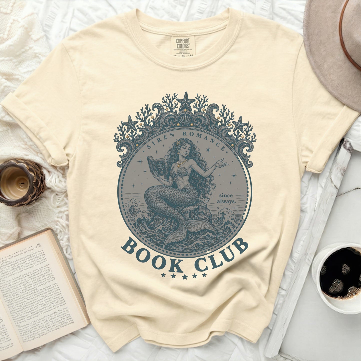 Cream t-shirt with a mermaid reading a book, text "Siren Romance Book Club".