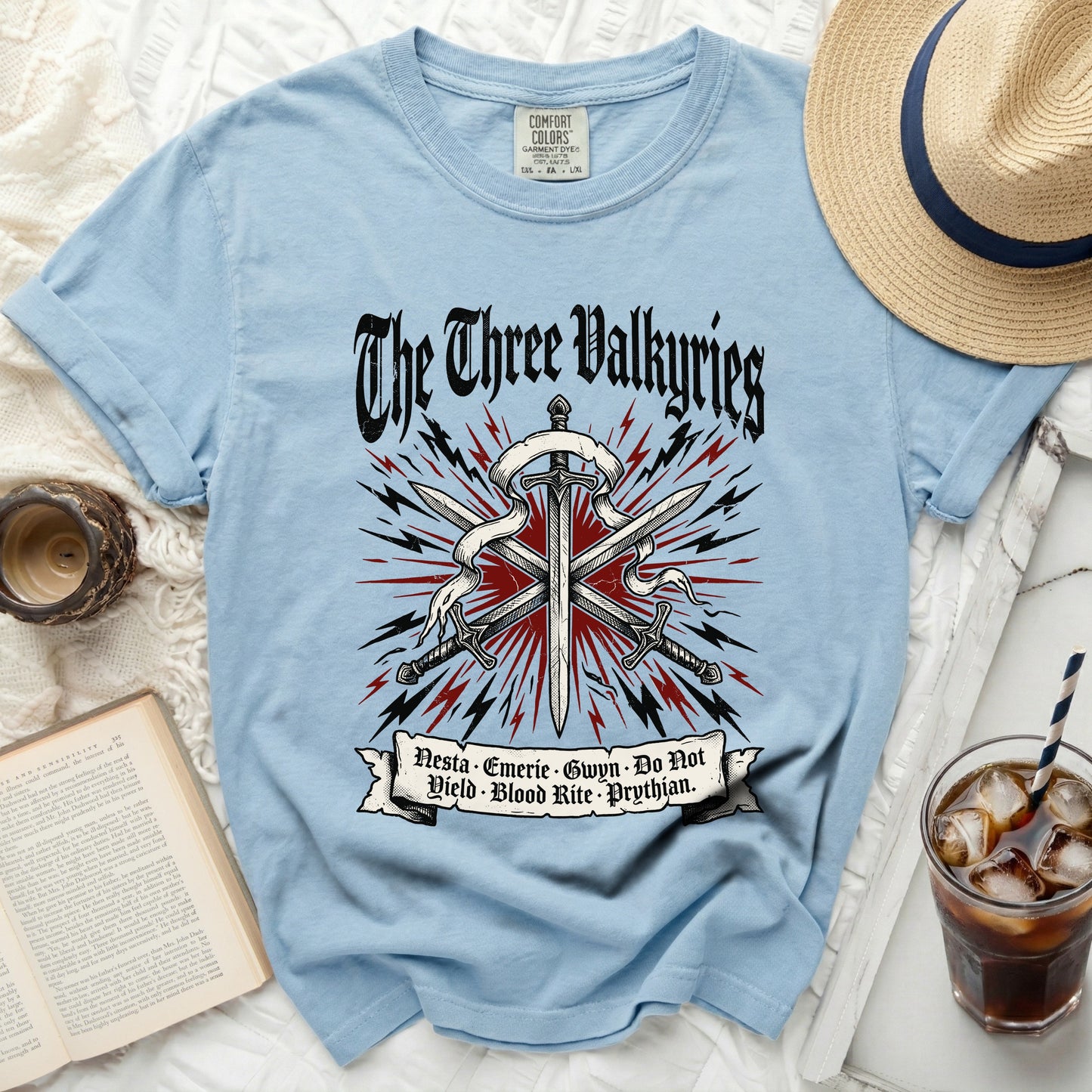 Light blue t-shirt with "The Three Valkyries" graphic and sword design.
