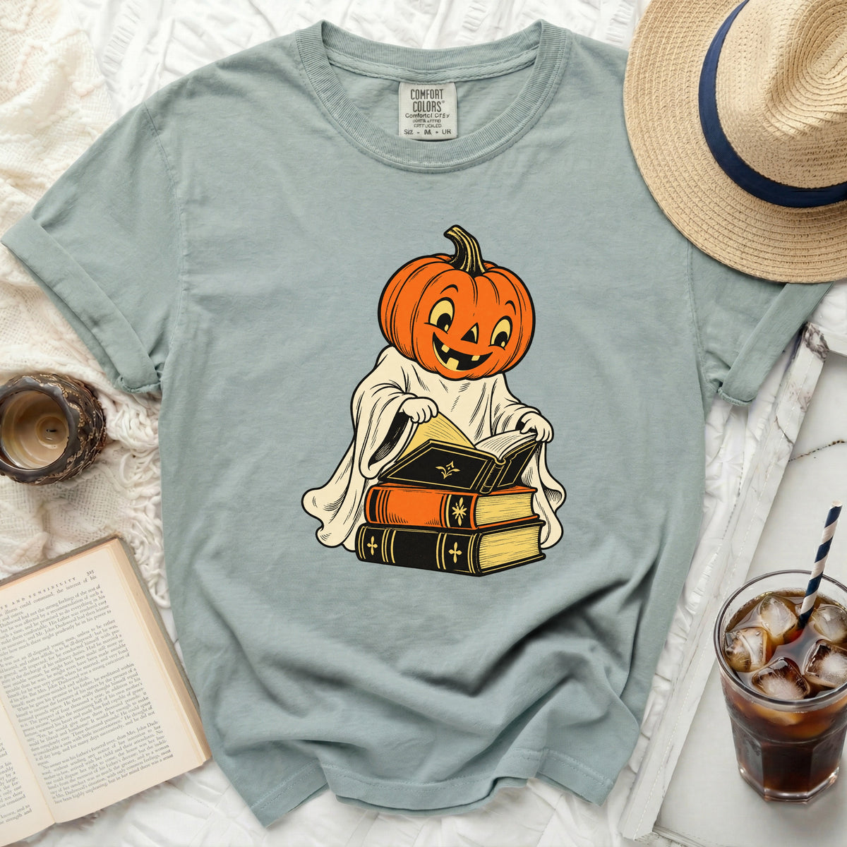 Ghost and pumpkin character reading books with Comfort Colors logo.